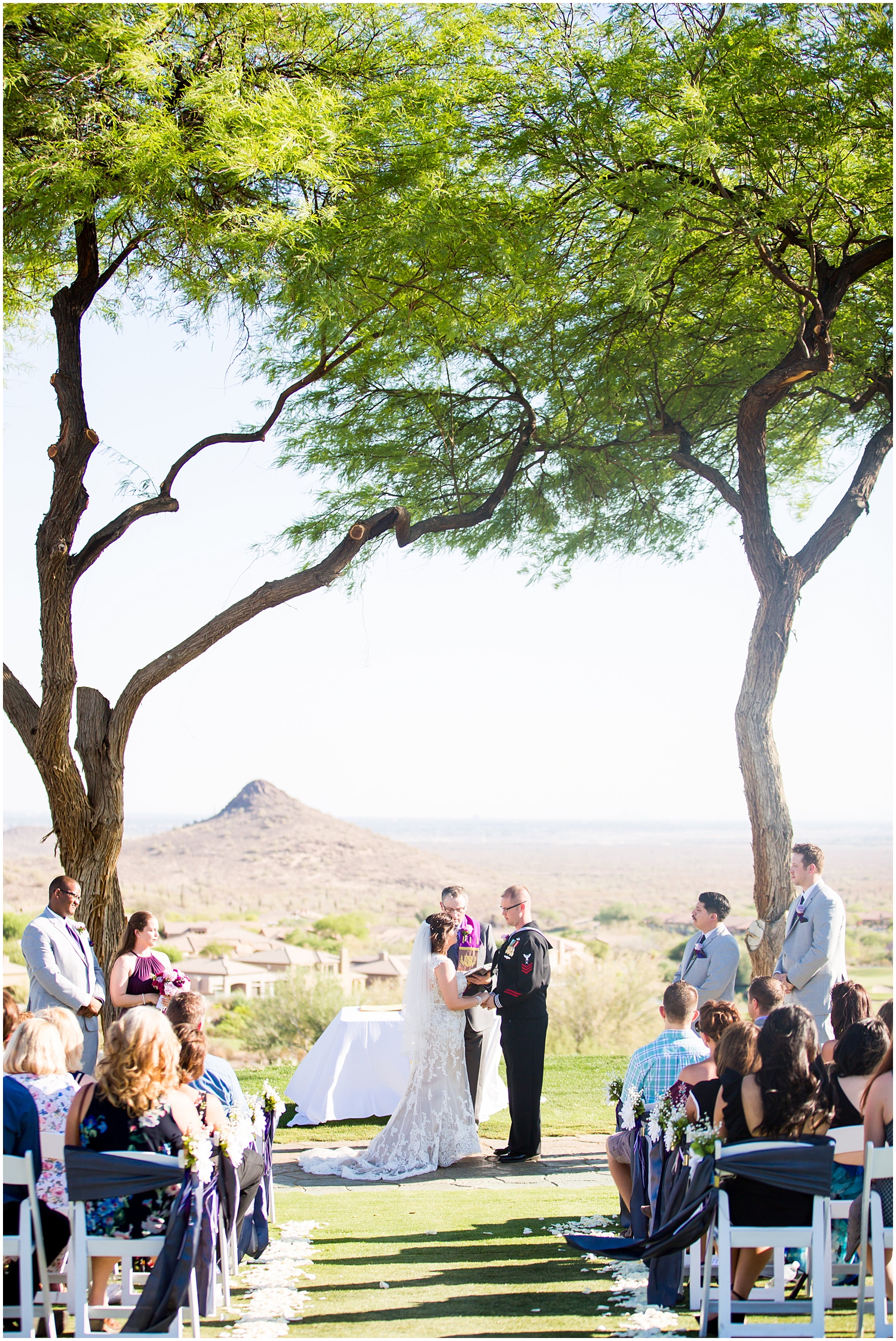 bride in strapless dress with groom in Navy dress uniform during outdoor ceremony