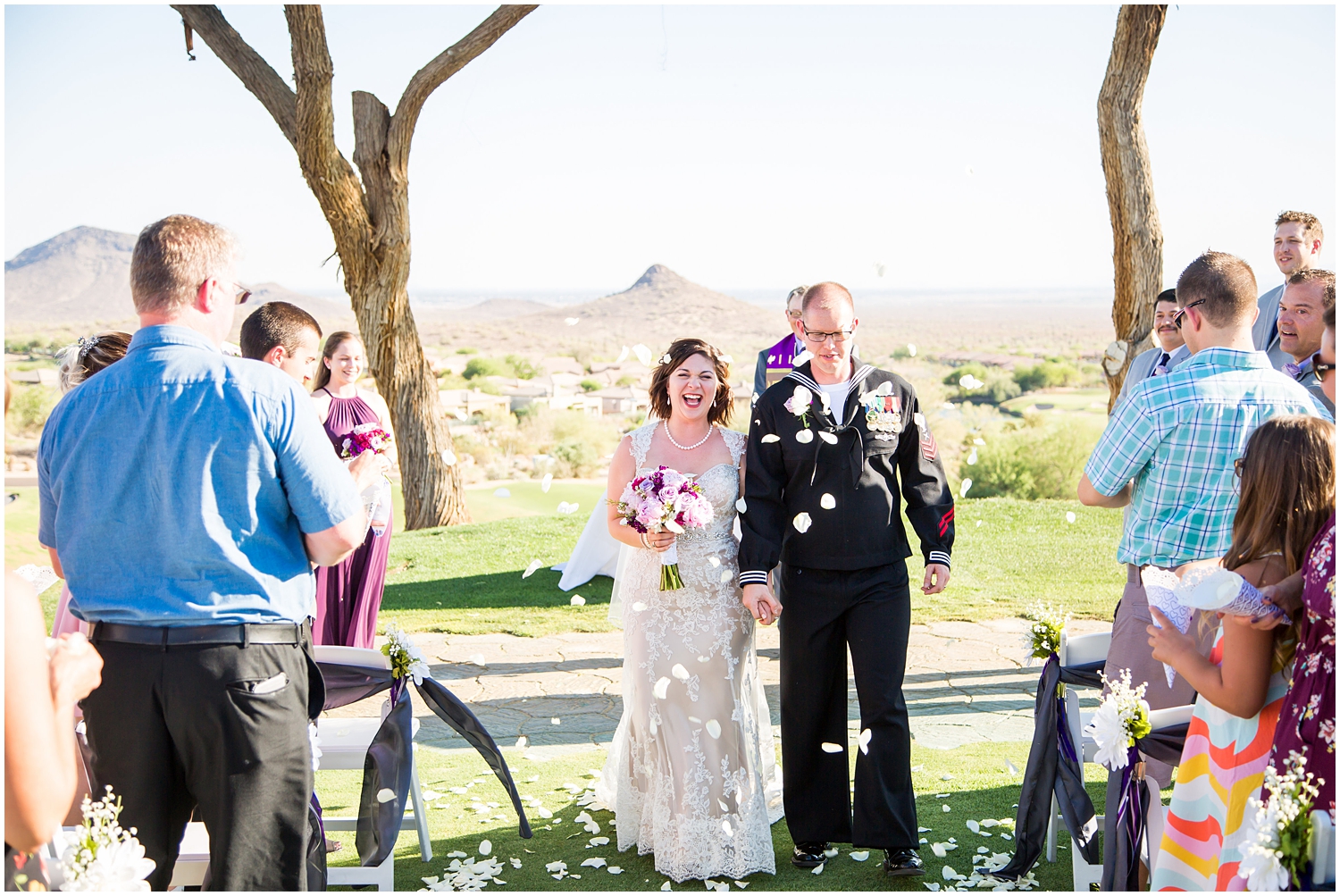 bride in strapless dress with groom in Navy dress uniform walking down aisle at outdoor ceremony