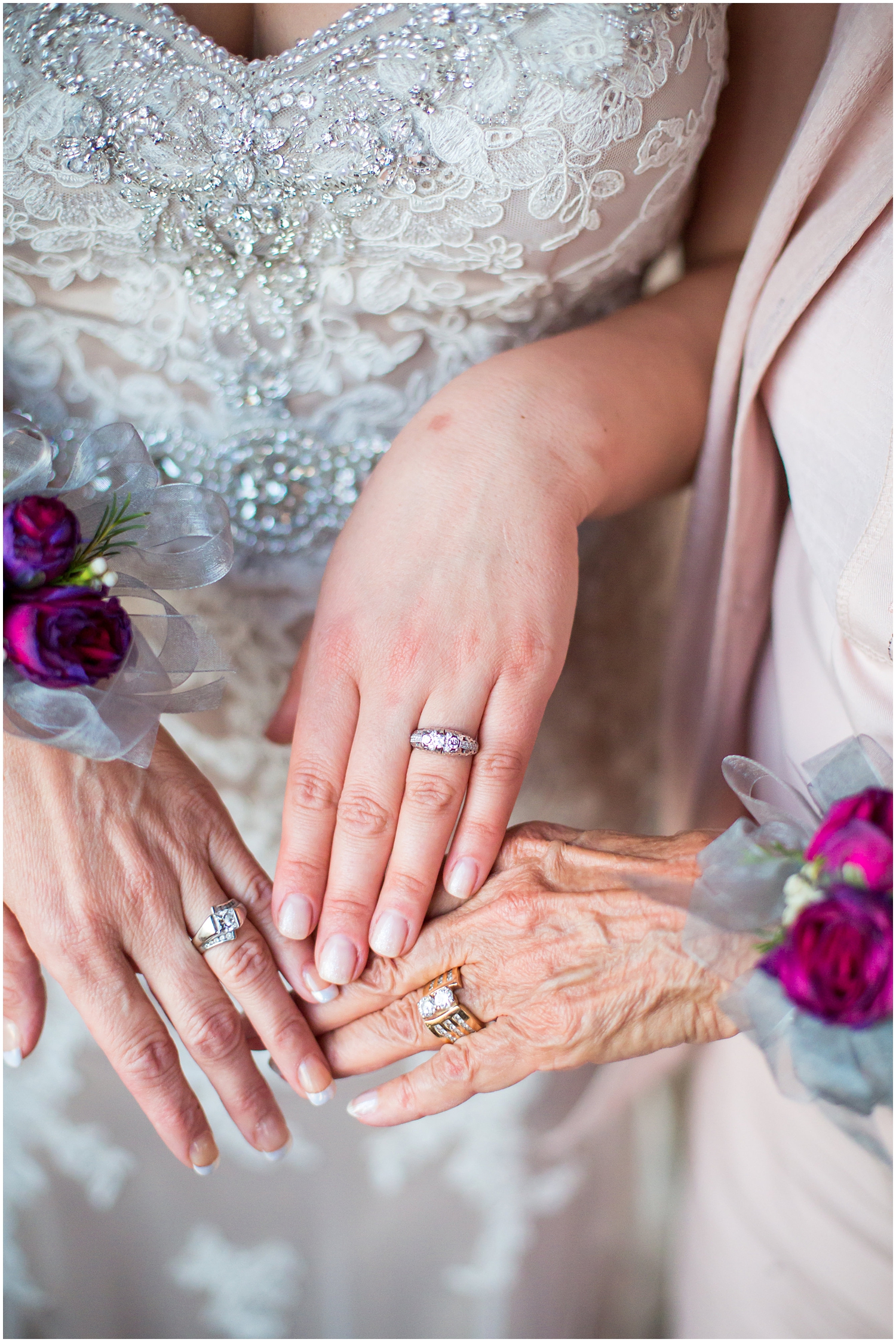 three generations of hands wearing wedding rings and bands together