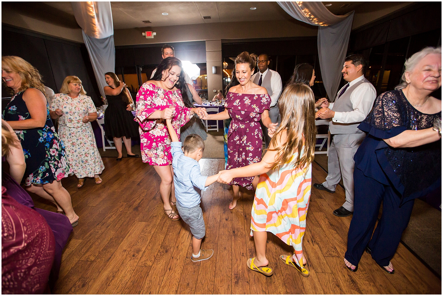 wedding guests dancing in ballroom reception