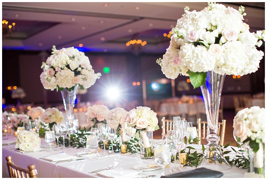 ballroom reception setup with gold chairs white large floral centerpieces at Omni Montelucia