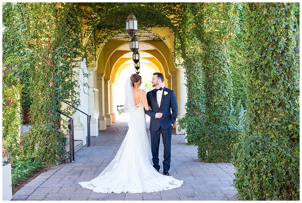 Elegant bride and groom portrait with green ivy walls at Omni Montelucia