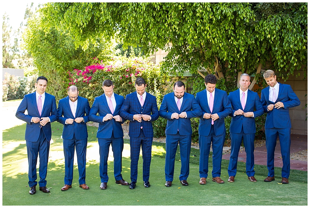 groom in custom royal blue suit with pink tie with groomsmen in blue suits