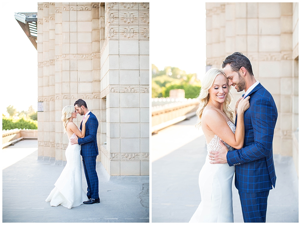 bride in two piece wedding dress and groom in custom blue suit on the rooftop at Arizona Biltmore