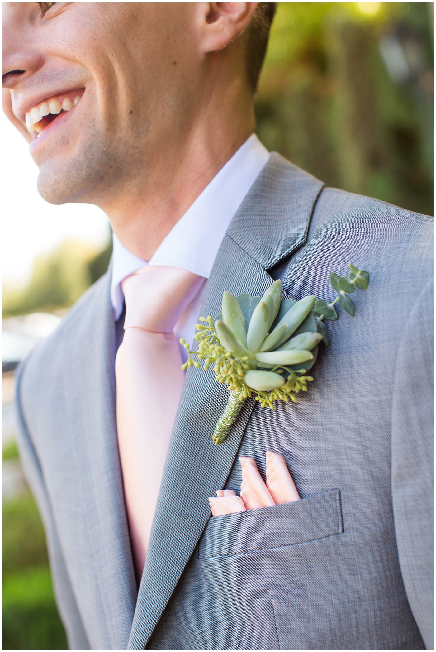 close up of groom's succulent boutonniere