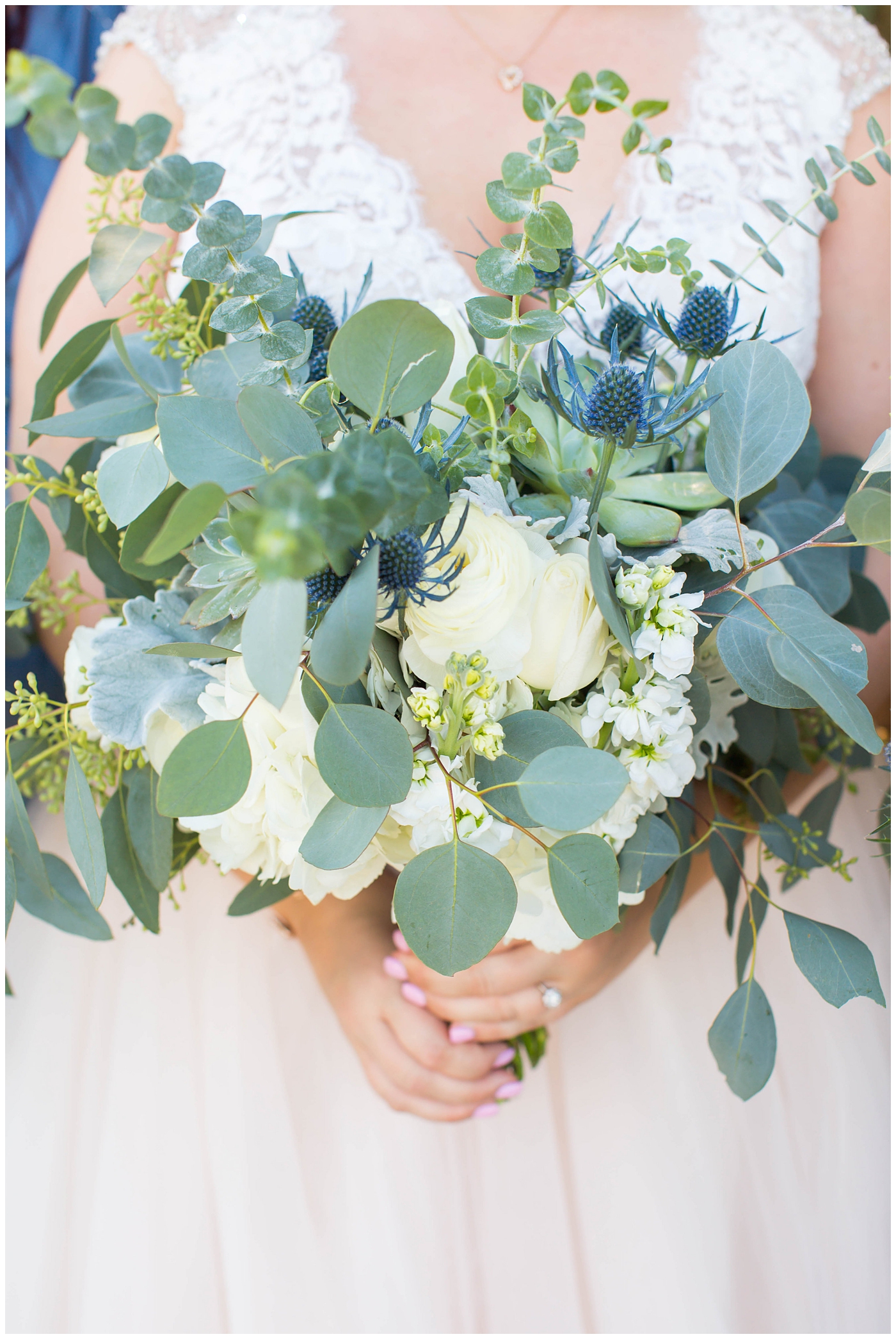 Bridal bouquet of white flowers, succulents, and greenery