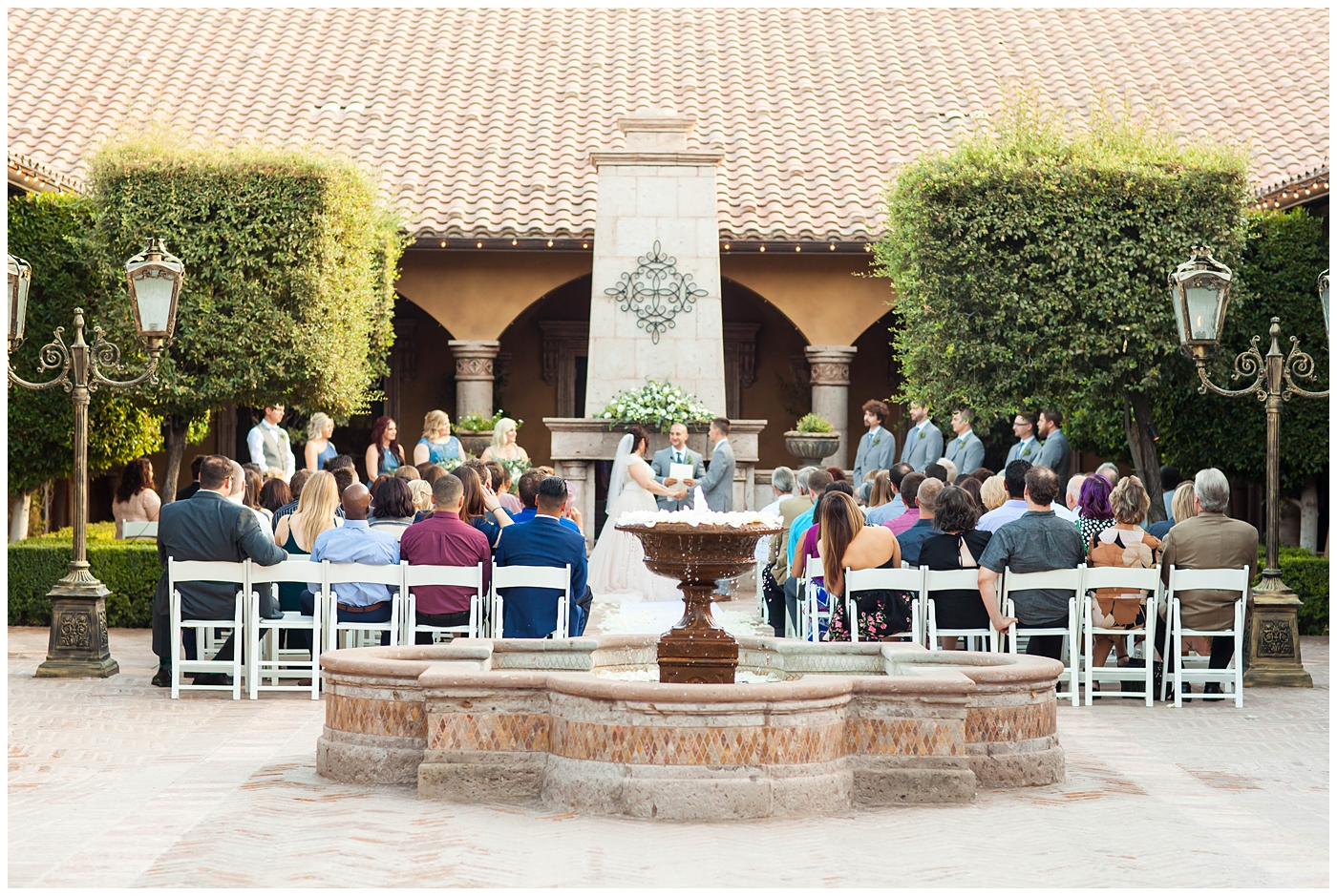 Bride and Groom holding hands during ceremony in Tuscan Courtyard