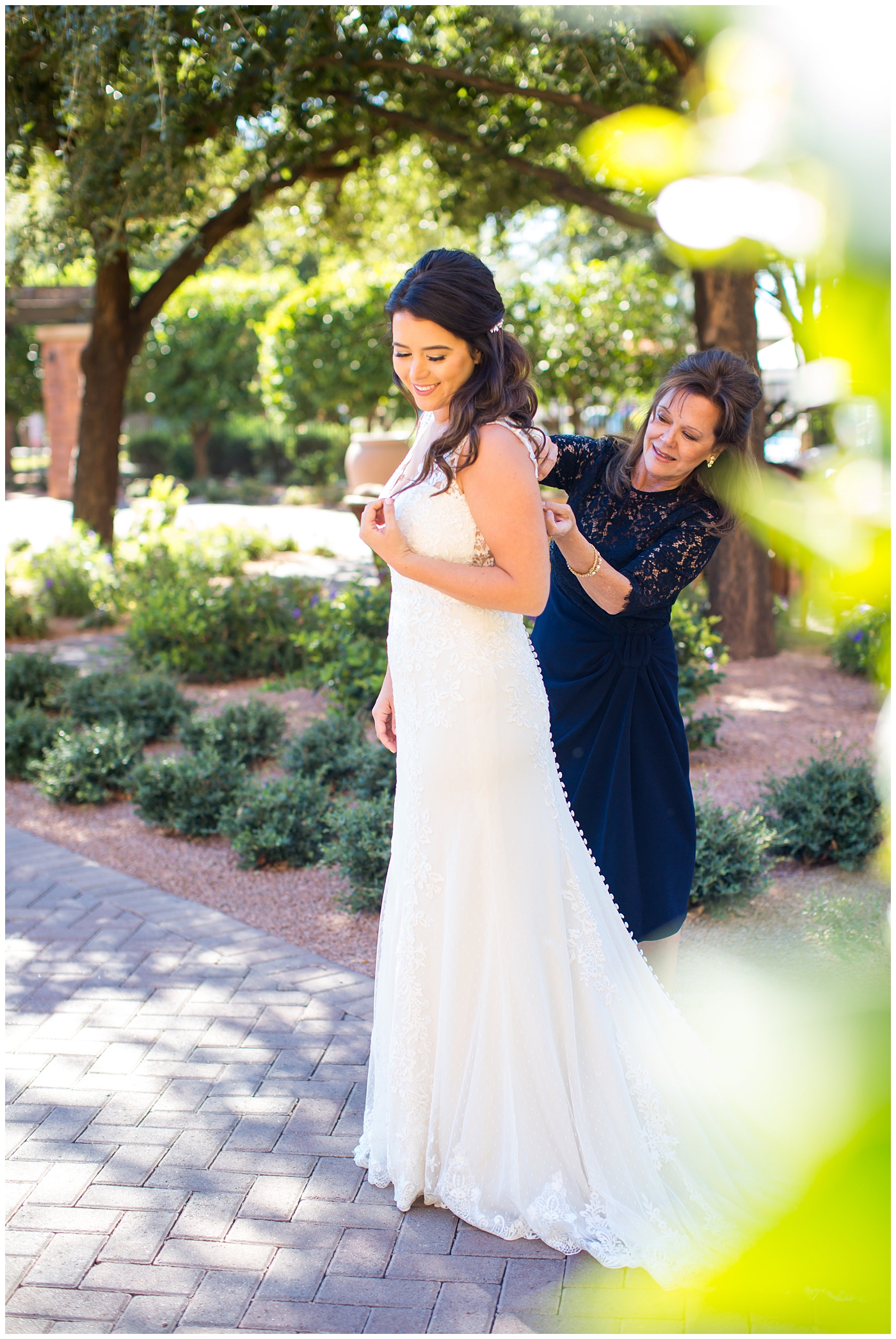 Bride getting ready with her mother in her Justina Alexander dress