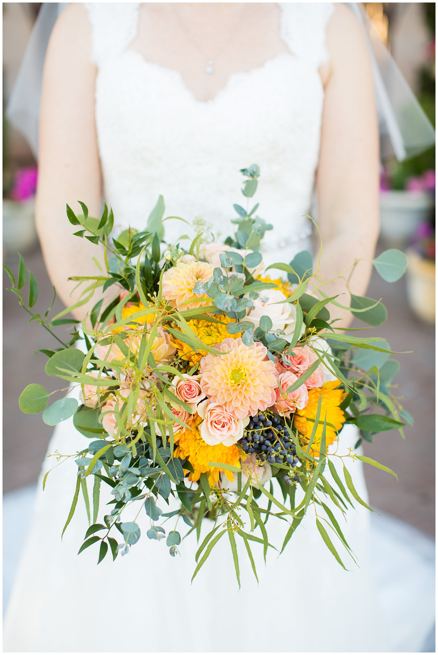 bridal bouquet with orange roses, greenery, yellow flowers
