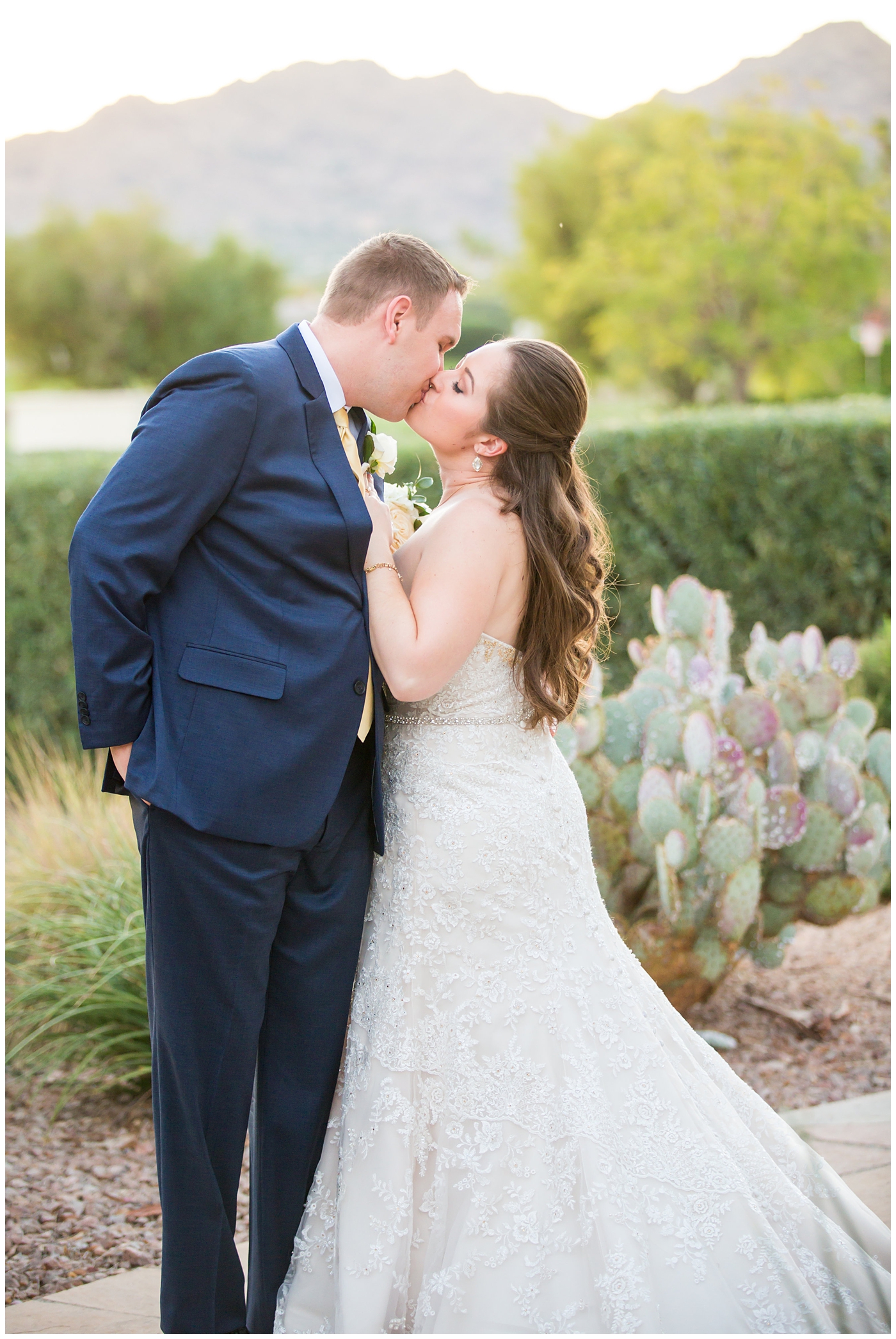 bride in lillian lottie couture wedding dress with white rose bouquet and groom in navy blue suit from men's warehouse bride and groom wedding portrait
