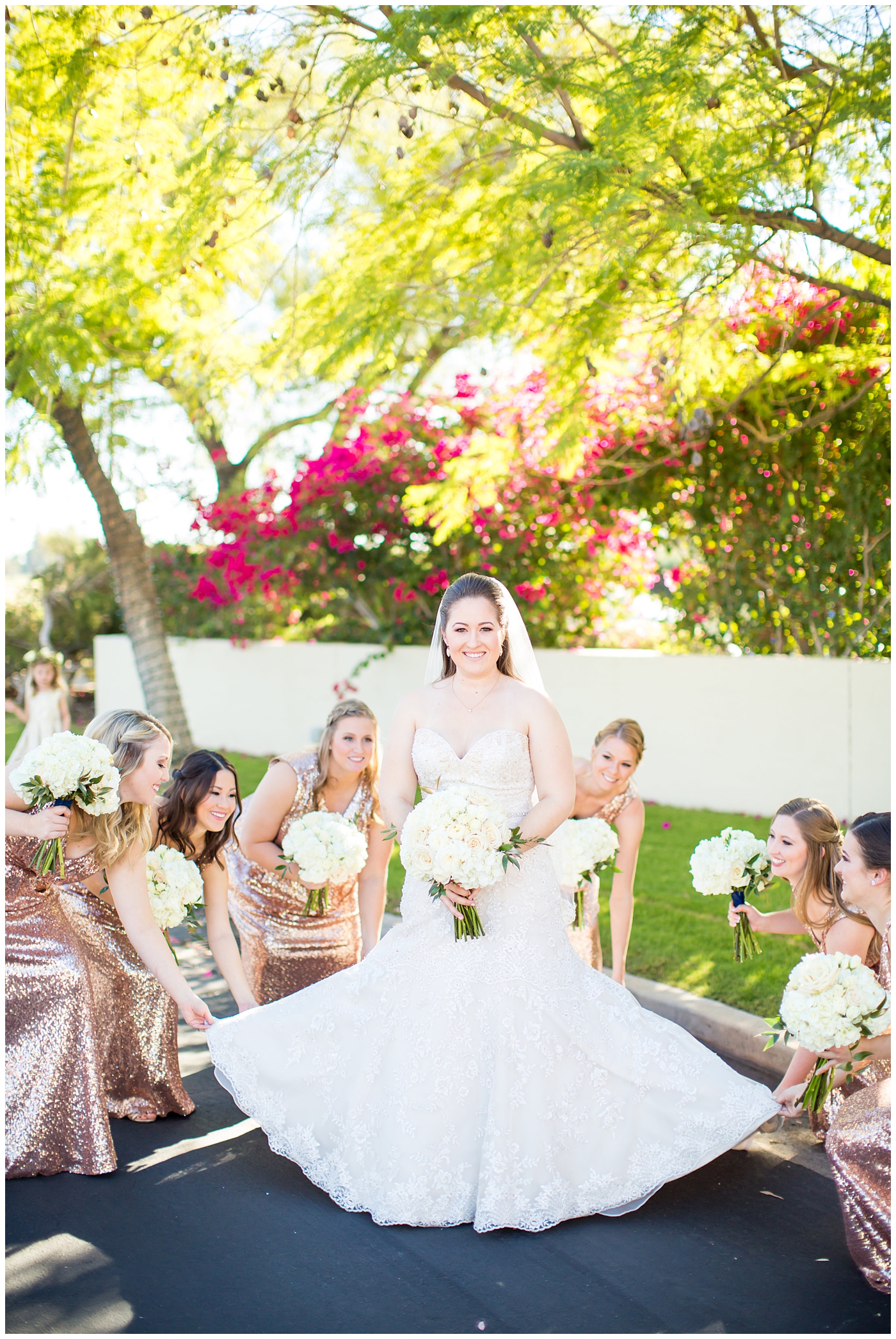 white rose wedding bouquet with bride in lillian lottie couture wedding dress and bridesmaids in rose gold sequin dress helping bride get ready