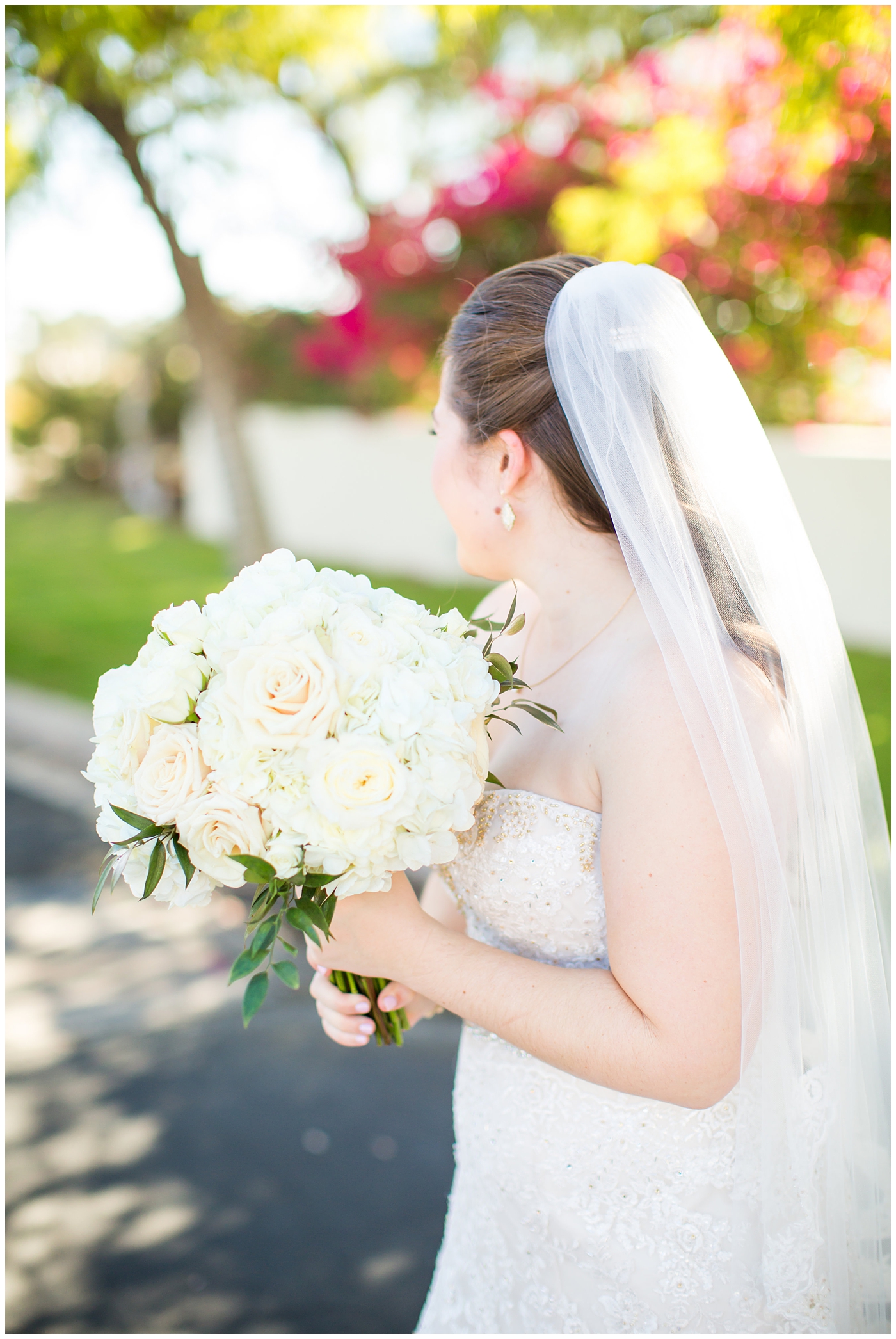 bride in lillian lottie couture wedding dress with white rose bouquet