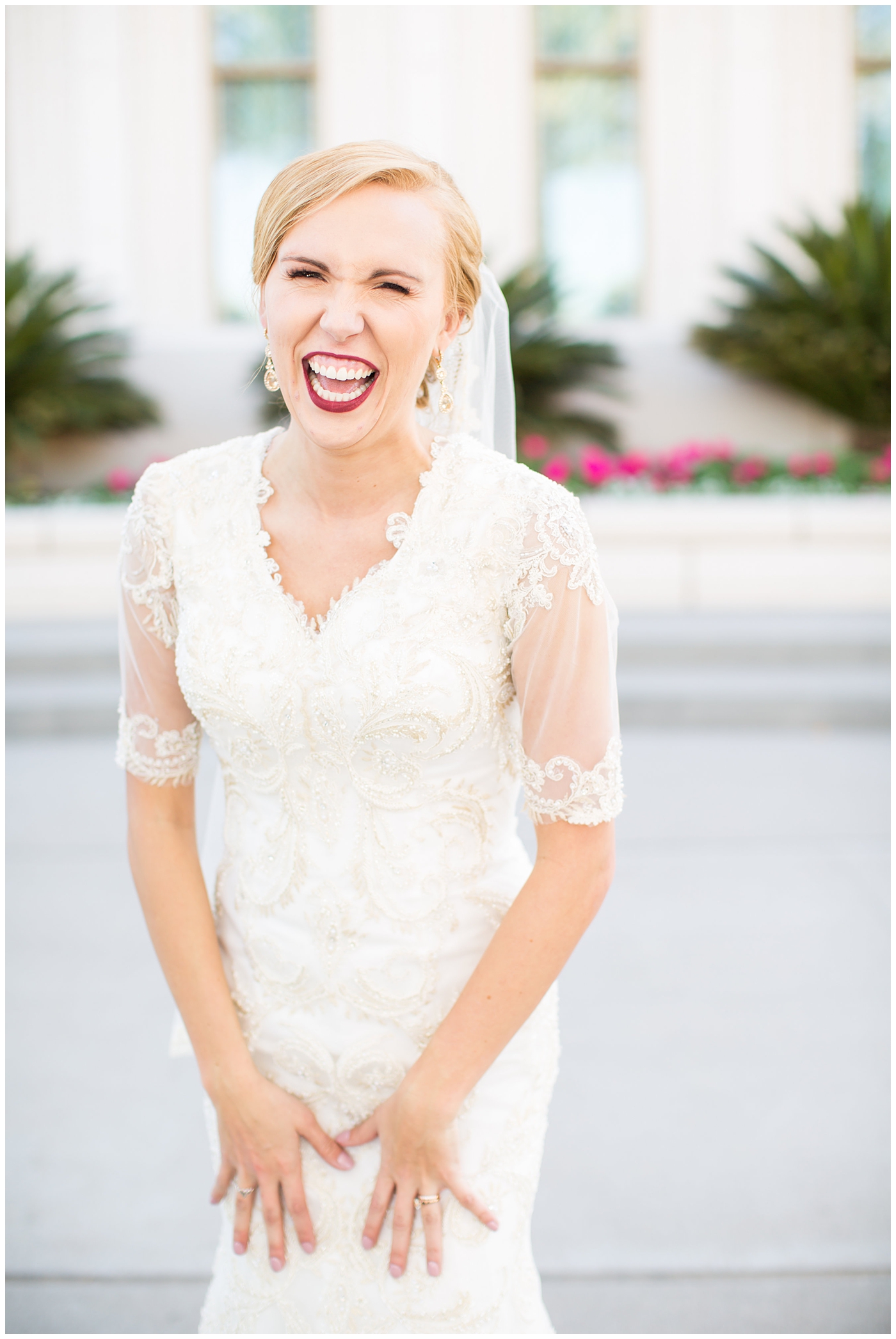 bride in sleeved lace dress with burgundy, white, and green wedding bouquet wedding day portrait at Gilbert LDS temple