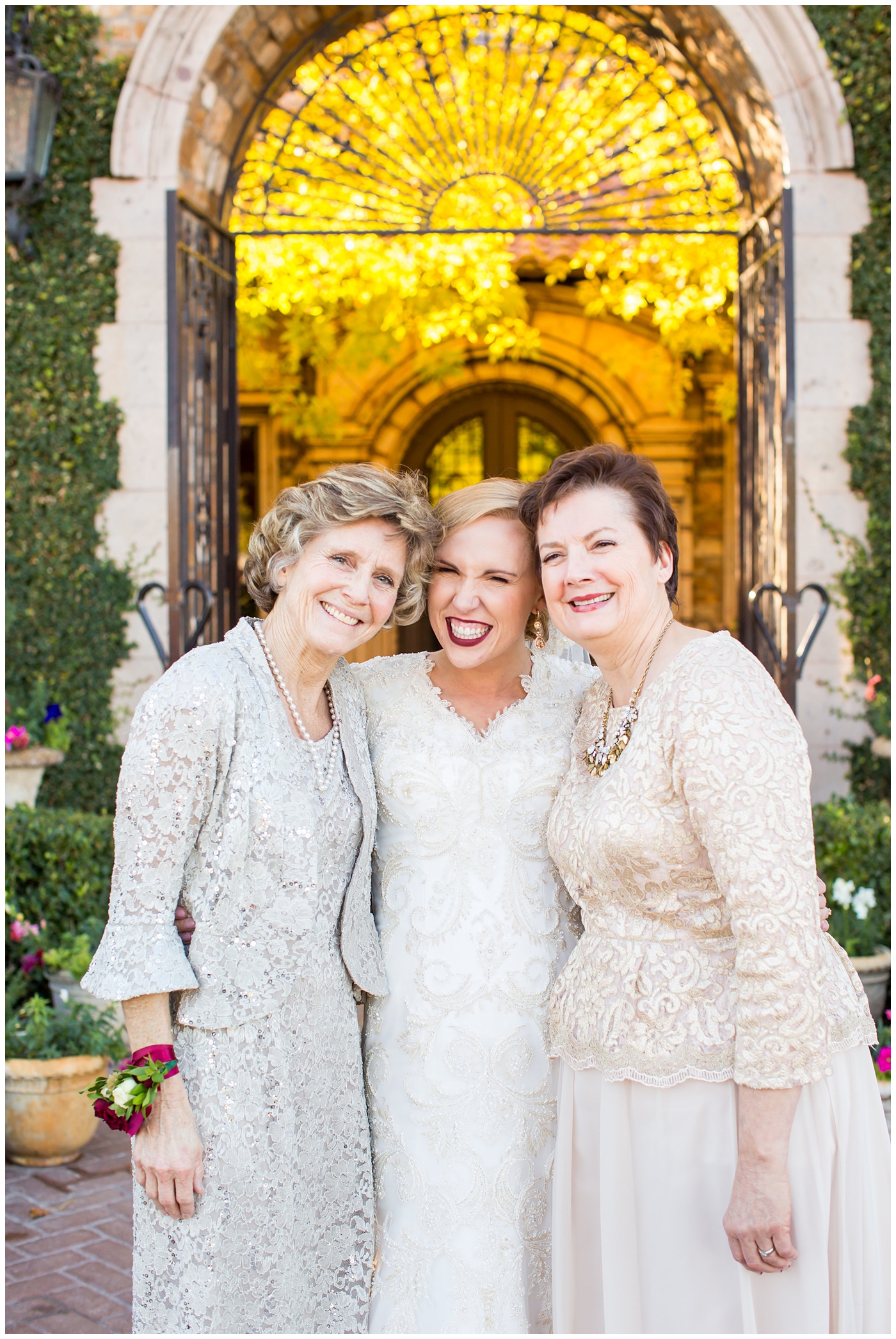 bride in sleeved lace dress with burgundy, white, and green wedding bouquet wedding day portrait with mother at Villa Siena