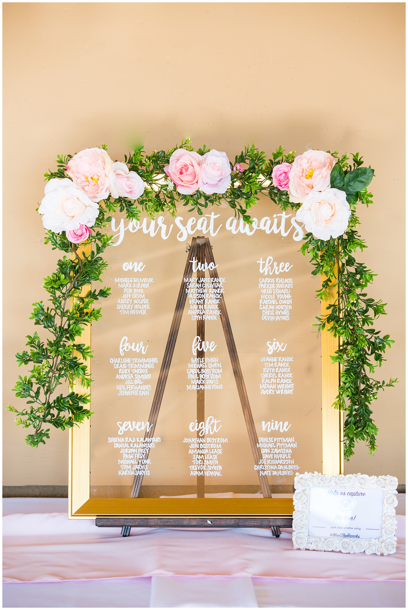 seating chart caligraphy gold frame with pink roses and greenery wedding reception detail
