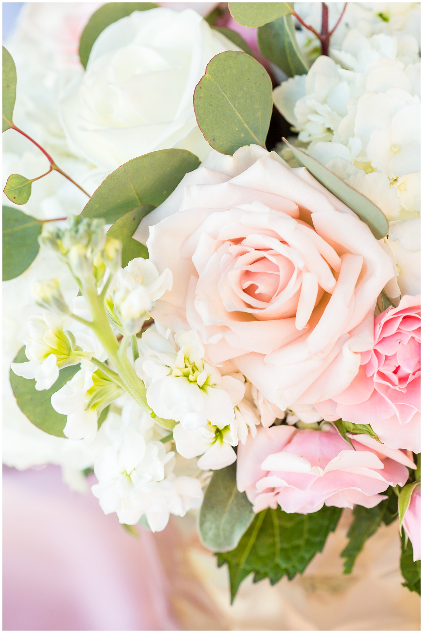 pink roses and eucalyptus wedding reception table centerpiece