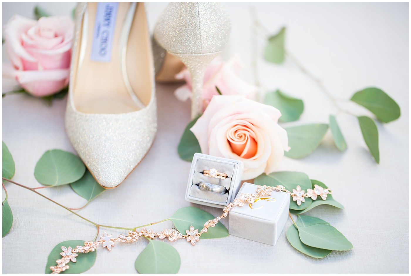 shiny gold jimmy choo wedding day shoes with rose gold wedding bands and silver ring in gray mrs. box on wedding day details