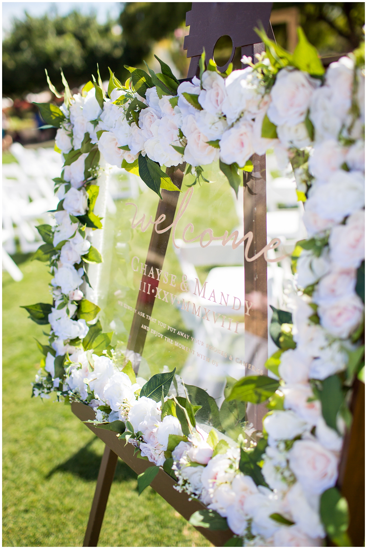 glass wedding sign with gold print and flower frame