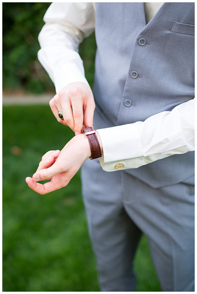 groom in light gray suit with tie tie getting ready at Arizona Biltmore