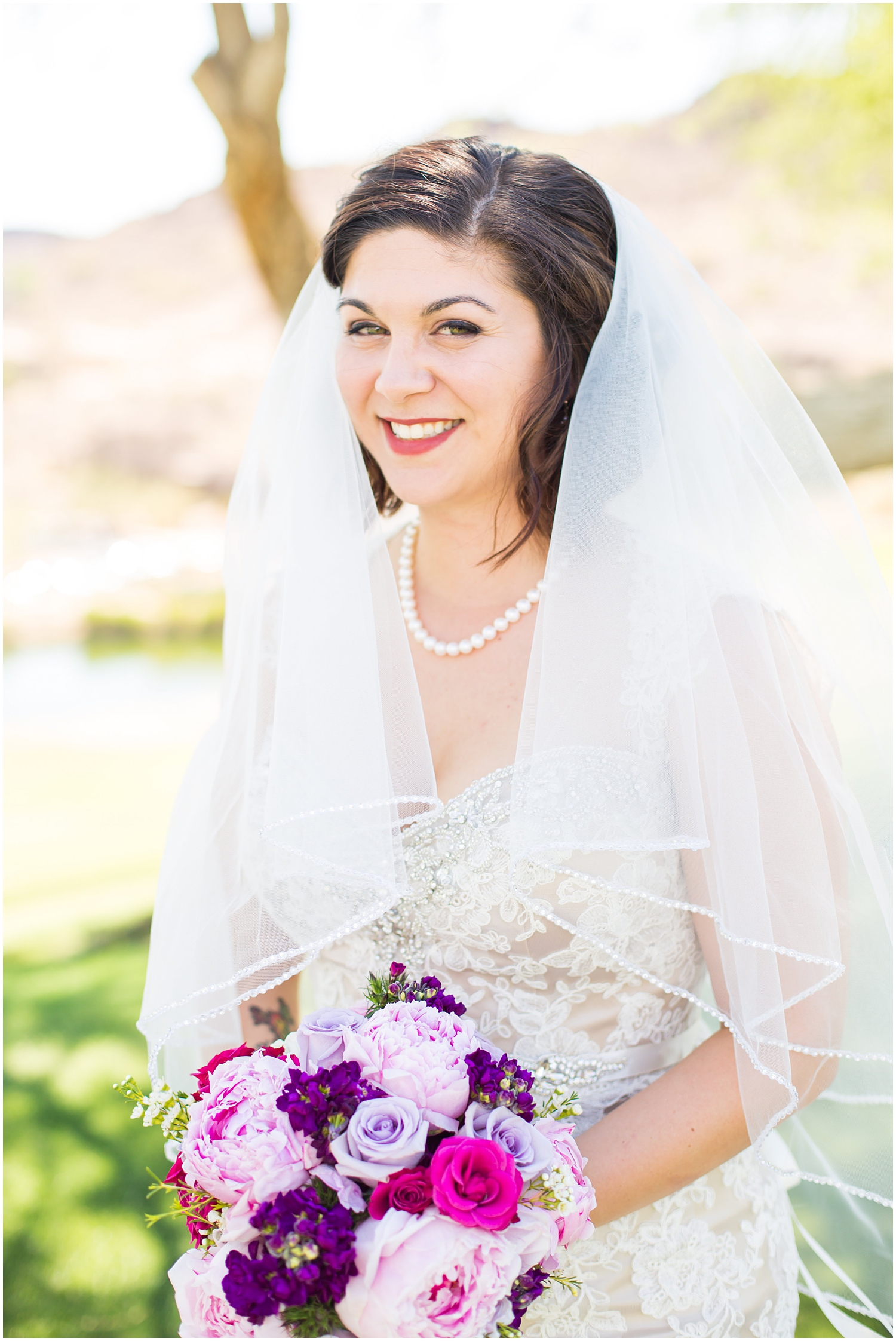 bride in strapless dress with veil and purple lavender peony and rose bouquet wedding day portrait